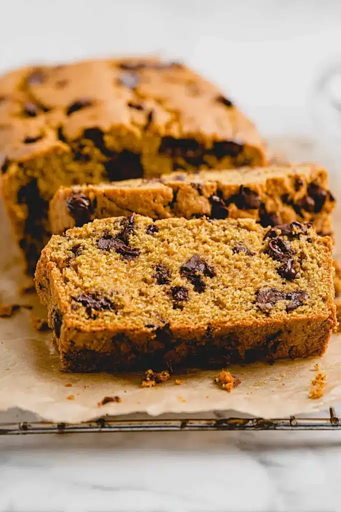 Sliced vegan pumpkin chocolate chip bread showing moist crumb and chocolate chunks
