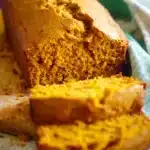 Freshly baked homemade pumpkin bread loaf sliced to reveal soft, moist texture