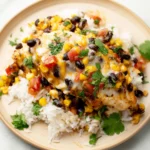 Santa Fe chicken served over white rice with corn, black beans, and melted cheese