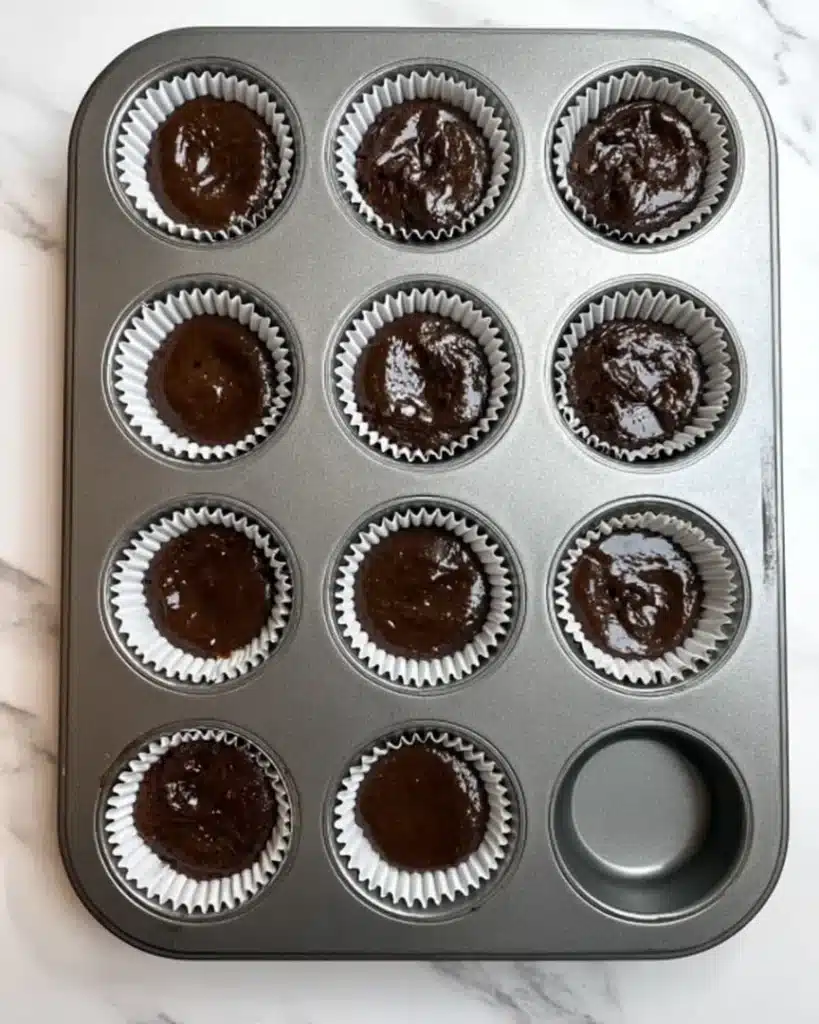 Muffin tray filled with chocolate batter for Halloween Vampire Bite Cupcakes
