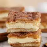 Churro cheesecake bars with cinnamon sugar crust and creamy filling