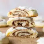 Stacked cinnamon roll cookies with gooey cinnamon filling and cream cheese frosting