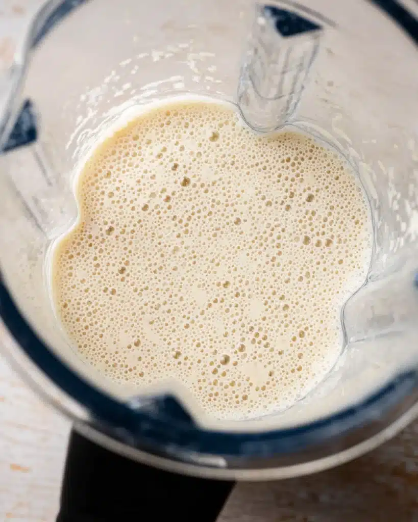 Blender with frothy custard mixture for ham and cheese croissant bake