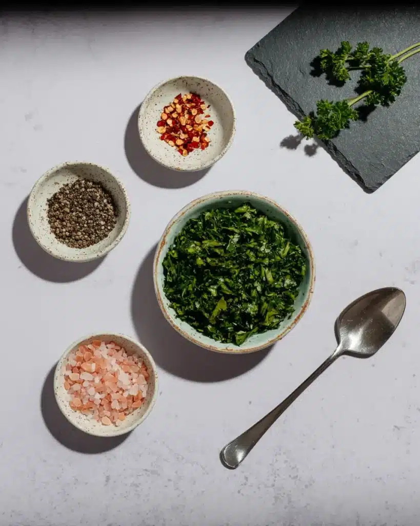 Fresh parsley, pepper, salt, and spices for creamy garlic Parmesan chicken pasta