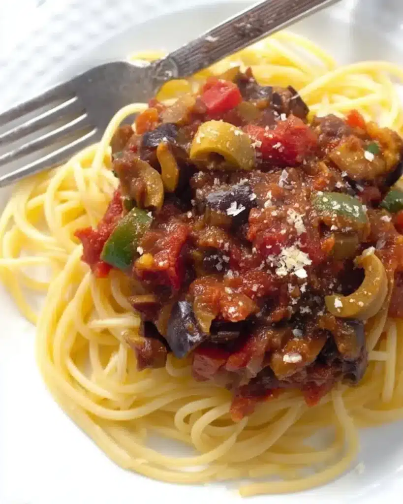 Easy Mediterranean Eggplant Pasta Sauce simmering in a pan with tomatoes and vegetables