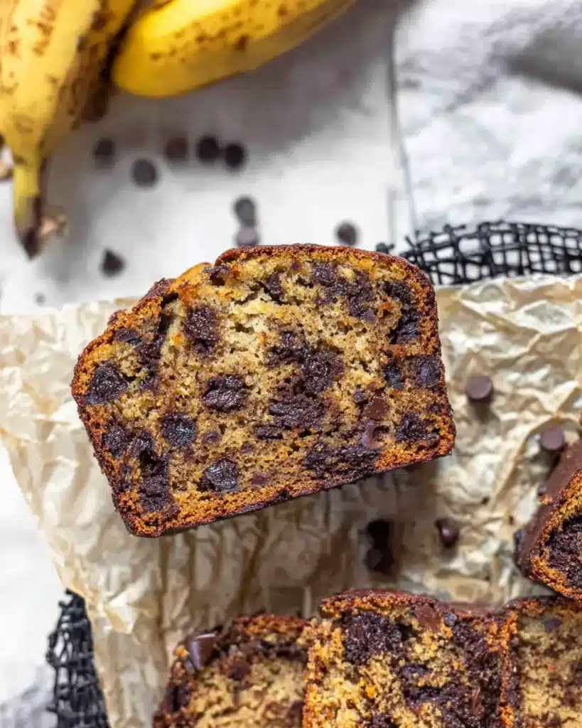 Close-up slice of super moist chocolate chip banana bread with gooey crumb