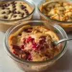 Close-up of spoon lifting strawberry baked protein pancake with melty peanut butter