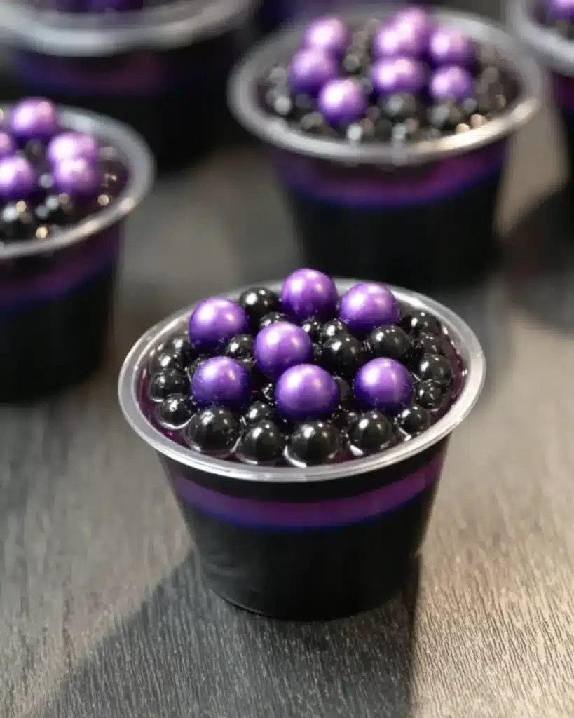Close-up of Black Magic Jello Shot with boba and purple candy pearls