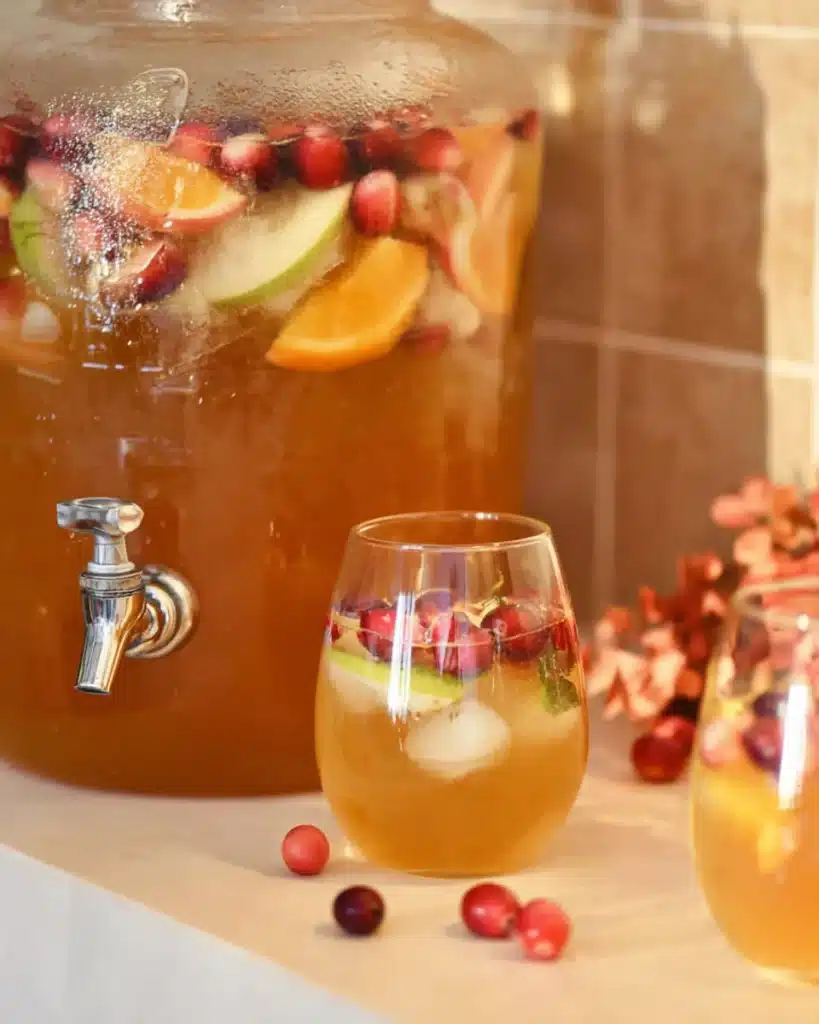 Close-up of caramel apple punch with fruit and sugared cranberries