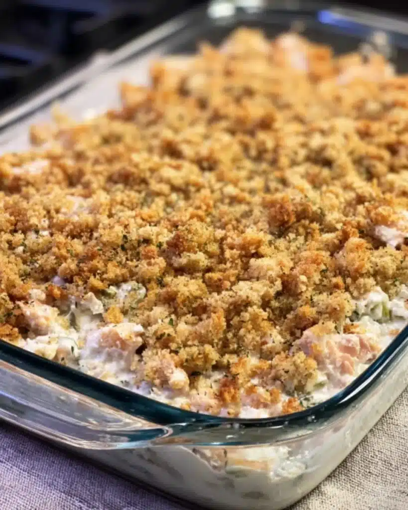Unbaked chicken and stuffing casserole with creamy base and moist stuffing topping