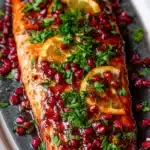 Glazed Christmas salmon with pomegranate seeds, oranges, and parsley