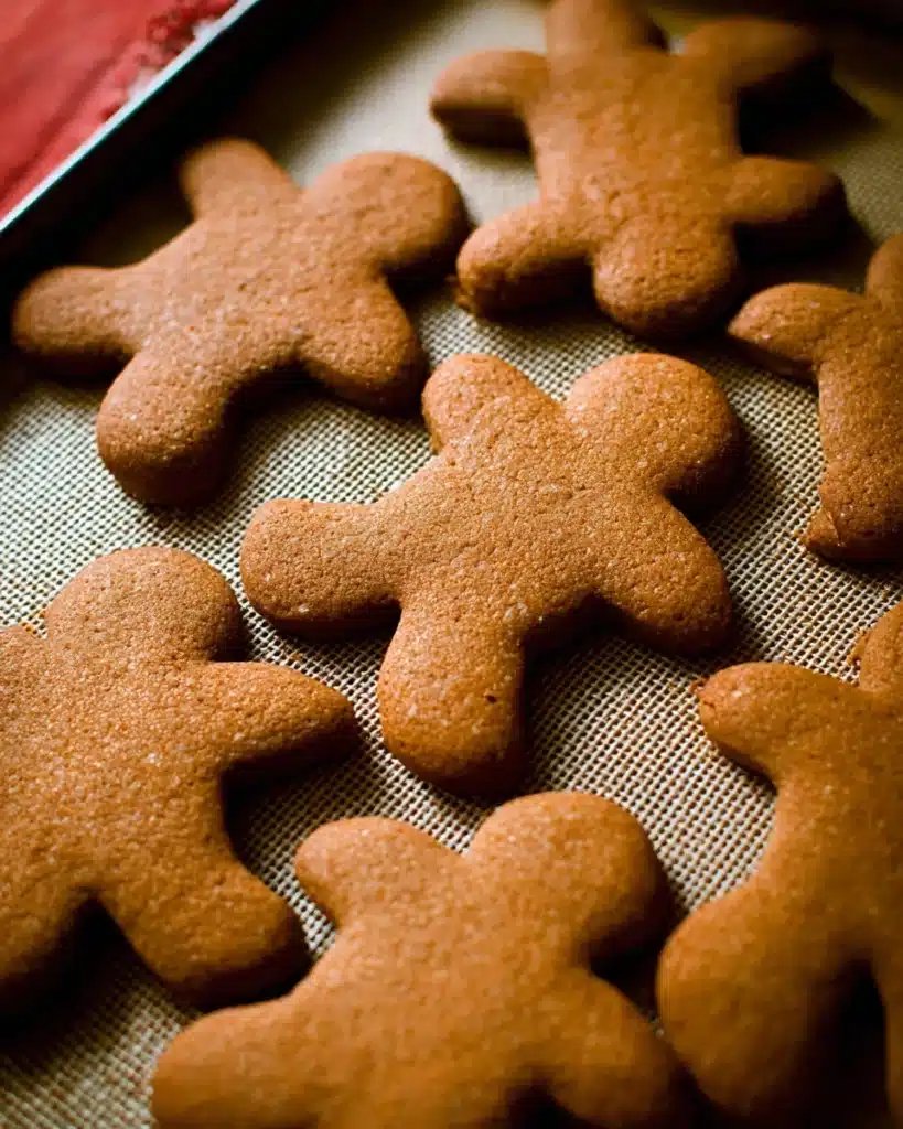 Freshly baked gingerbread cookies cooling on baking sheet