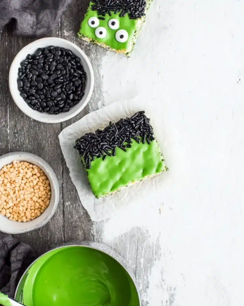 Frankenstein Rice Krispie bar dipped in green candy melts with black sprinkles