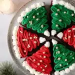 Frosted Christmas brownies decorated as trees and Santa hats on a holiday plate