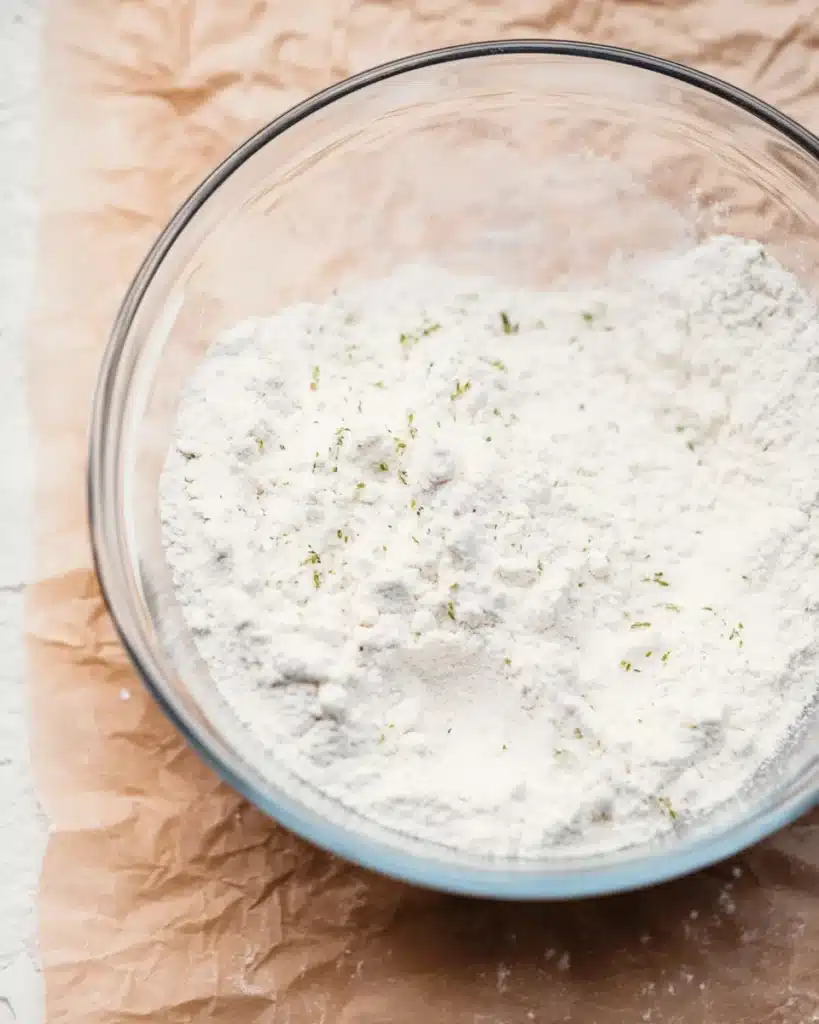 Glass bowl with flour mixture for garlic bread rolls