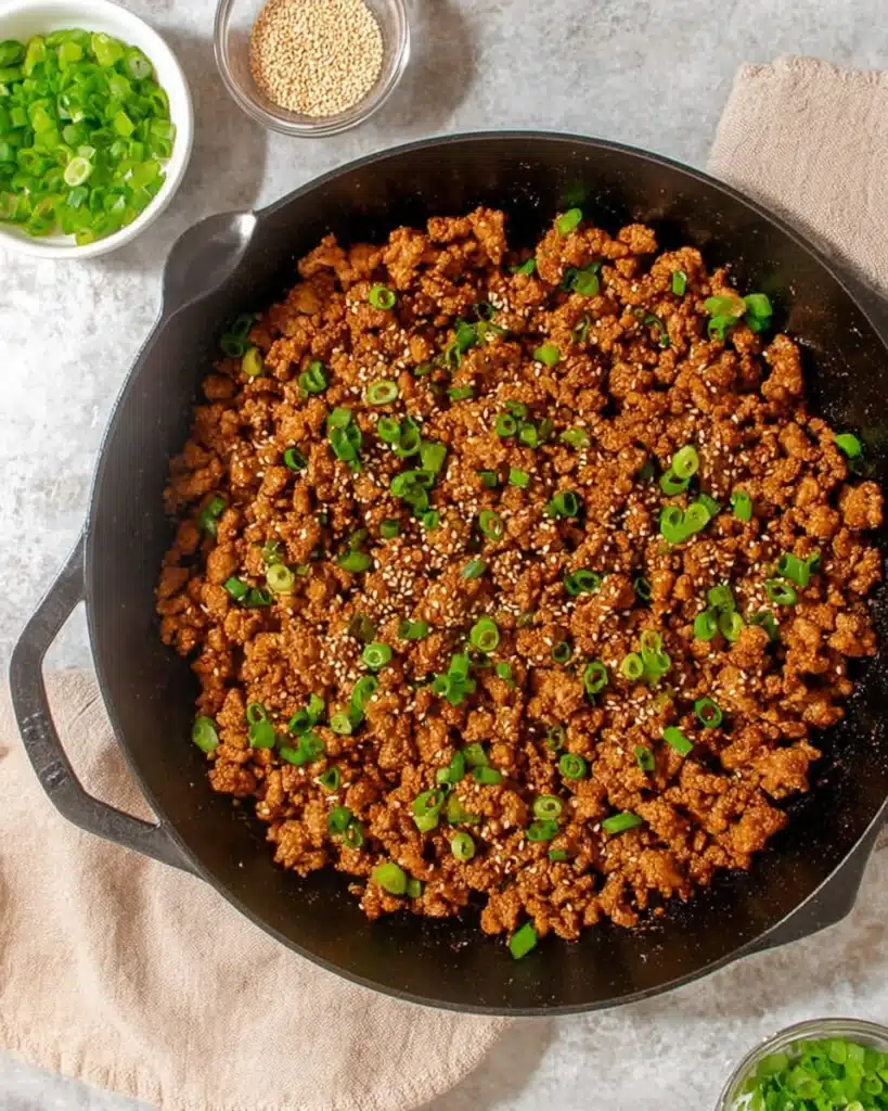 Finished ginger honey ground pork with sesame and green onion in skillet