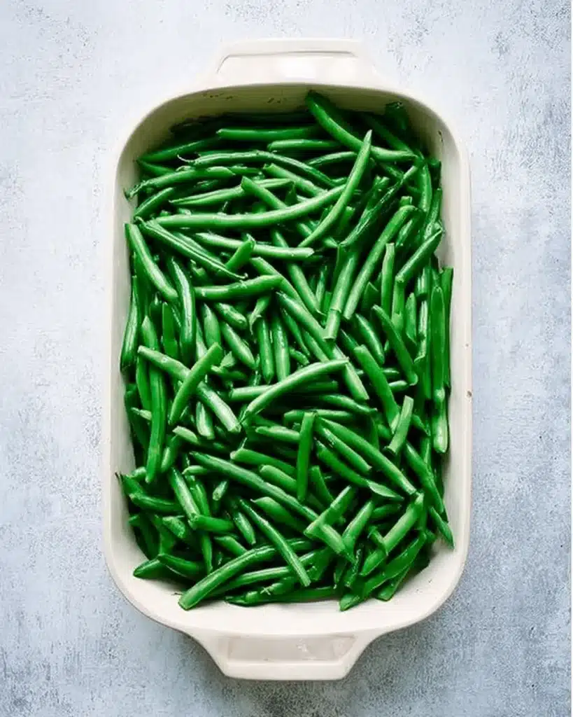 Fresh green beans in white baking dish for casserole prep