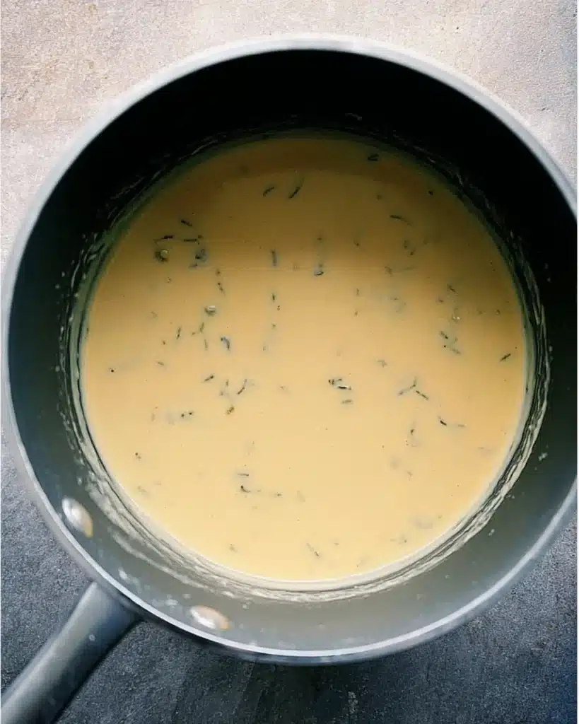 Homemade creamy cheese sauce in saucepan for green bean casserole