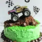 Monster truck birthday cake with green icing, Oreo dirt, and toy truck topper