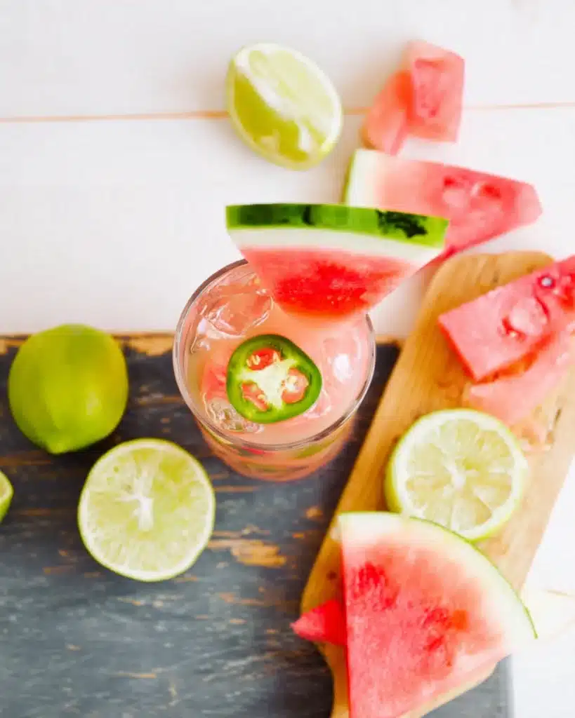 Top view of La Bruja Cocktail with watermelon wedge and jalapeño garnish