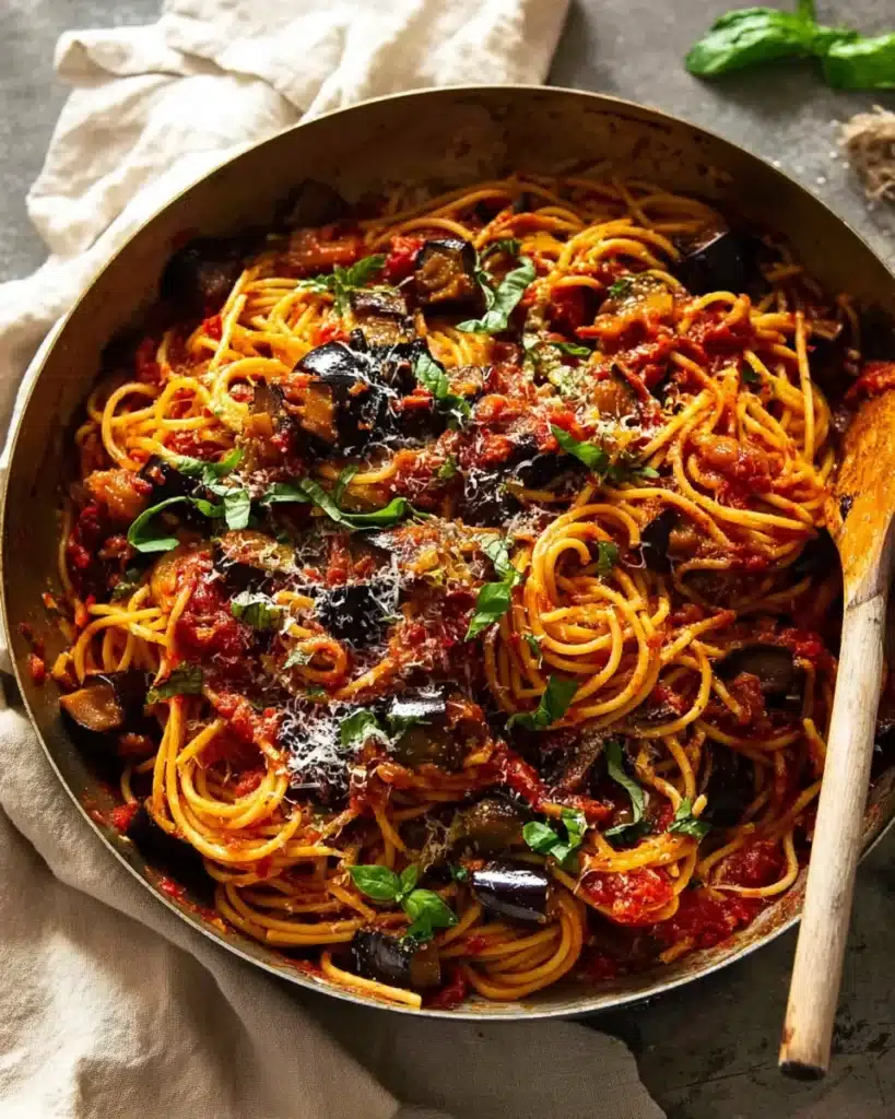 Skillet of Pasta alla Norma with eggplant, tomato sauce, and basil
