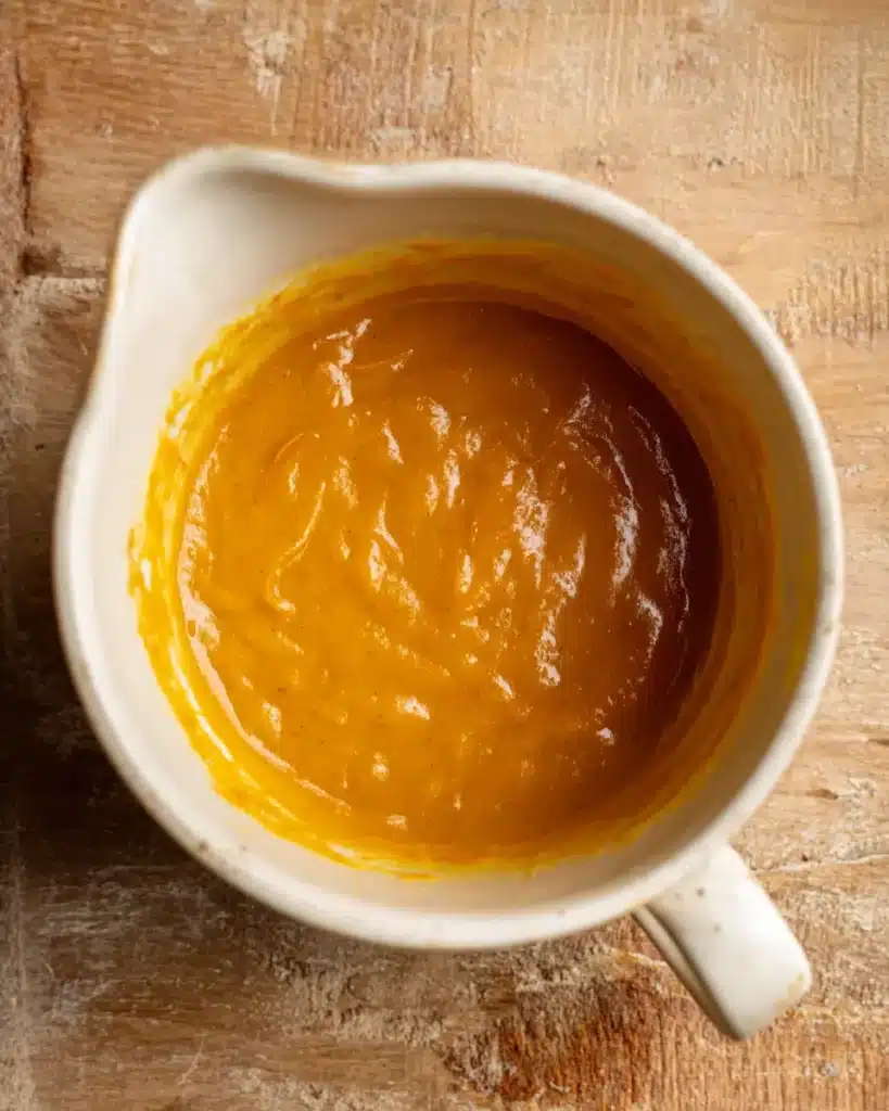 Wet pumpkin mixture for The Best Pumpkin Cupcakes in a mixing bowl
