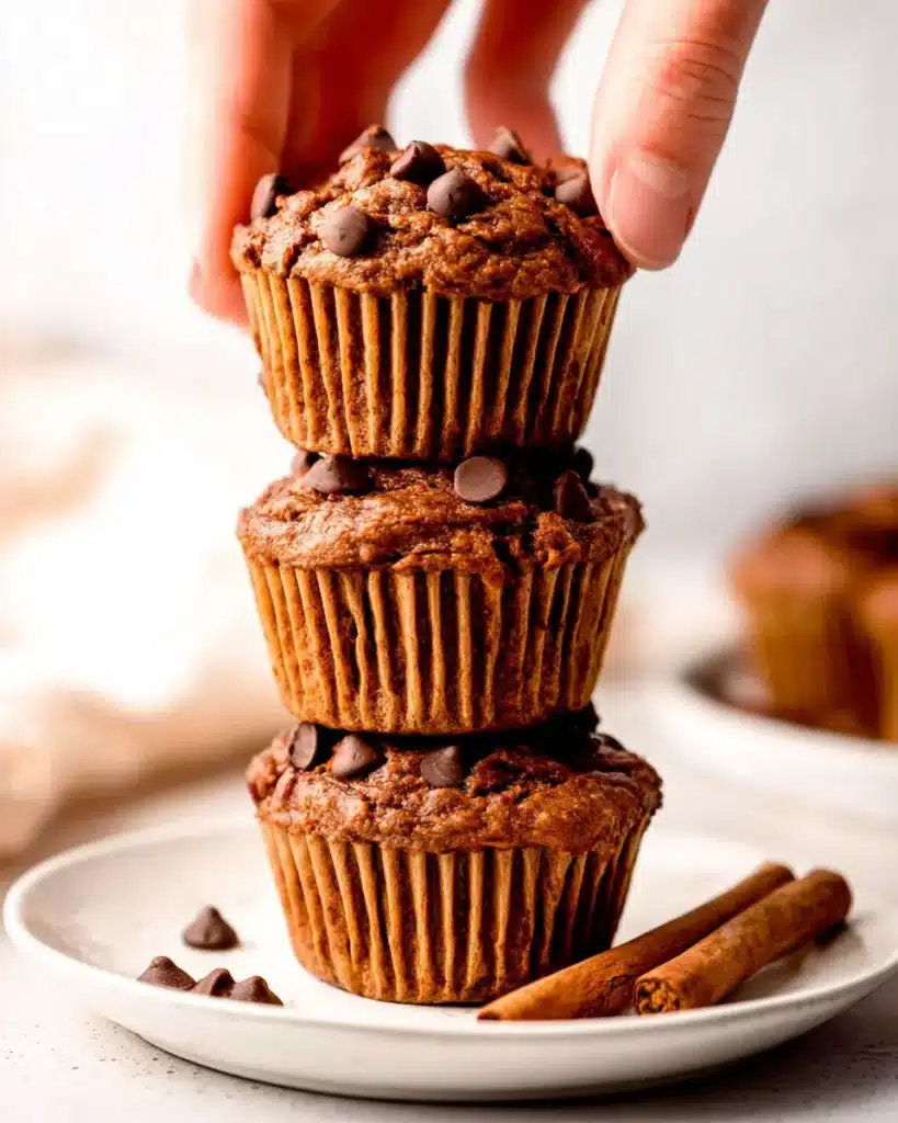 Stacked pumpkin chocolate chip muffins with cinnamon sticks