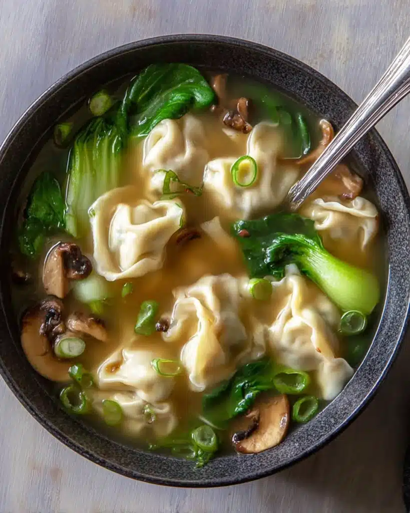 Bowl of quick and easy wonton soup with dumplings, bok choy, and shiitake mushrooms
