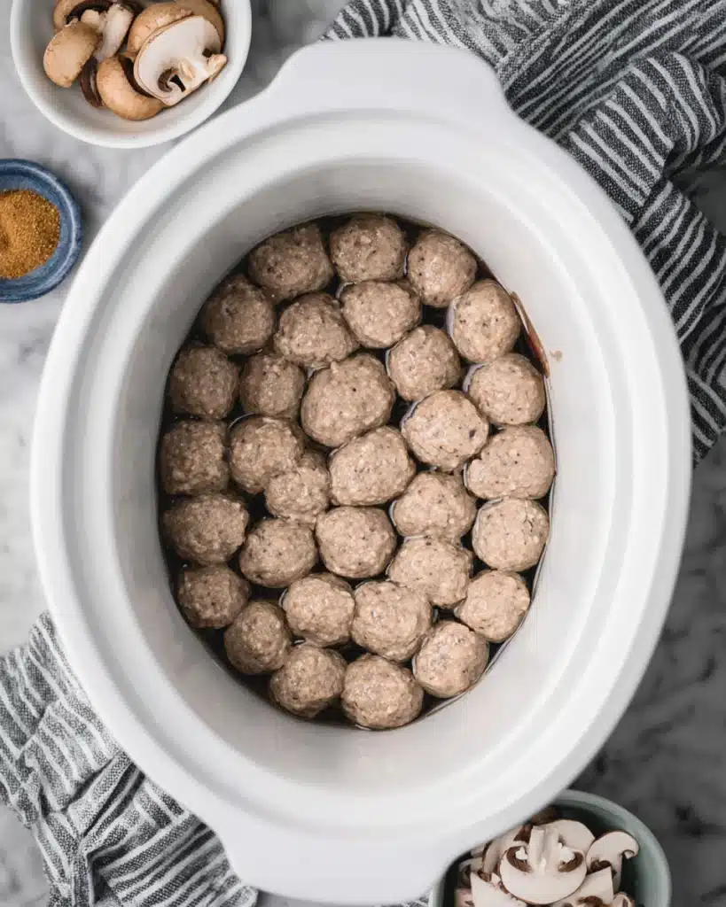 Frozen Salisbury steak meatballs in slow cooker before cooking