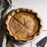 Salted maple pie with flaky crust and sea salt in rustic pie dish