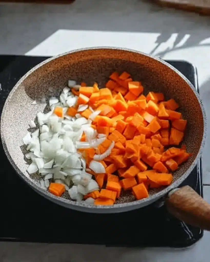 Chopped carrots and onions in pan for quick & easy wonton soup