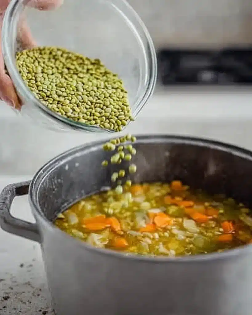 Pouring split peas into simmering broth for quick & easy wonton soup