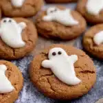 Pumpkin cookies with white chocolate ghost decorations for Halloween