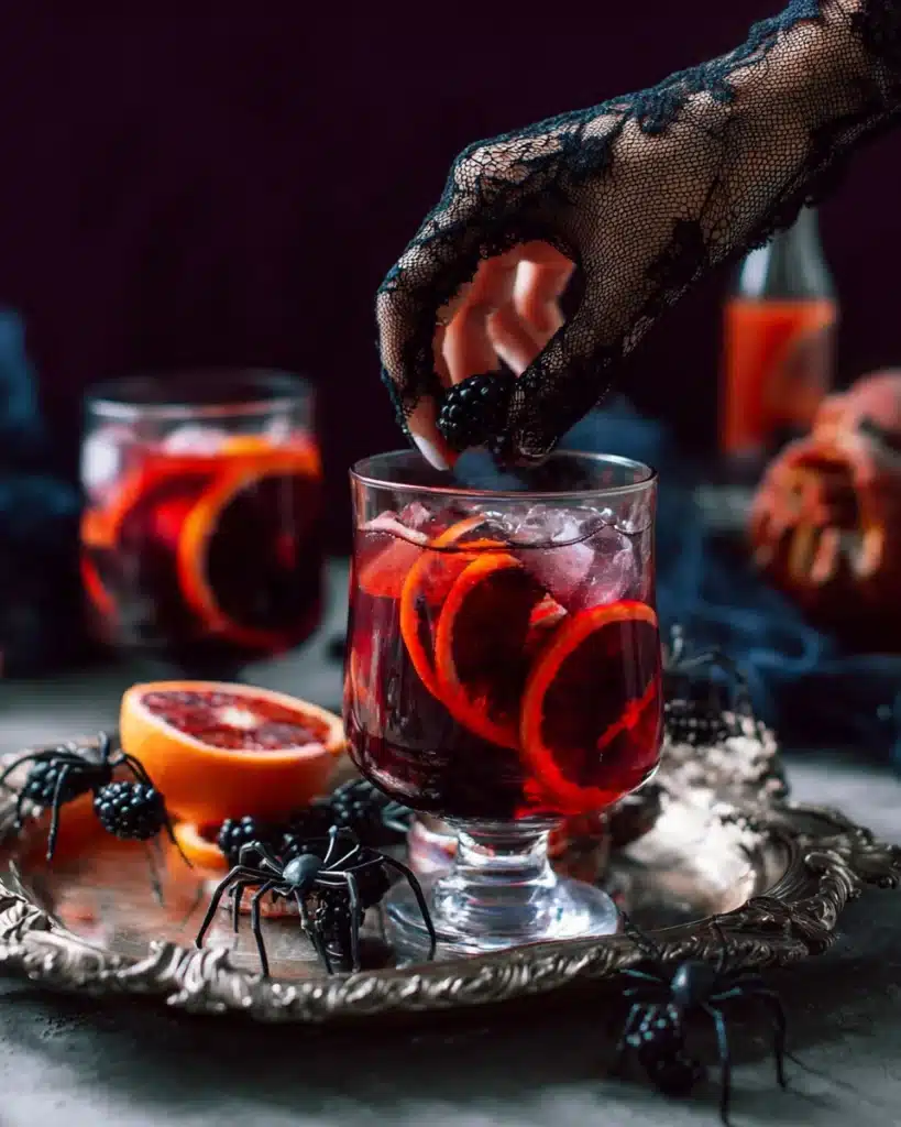 Spooky sangria served with blood oranges, blackberries, and lace glove