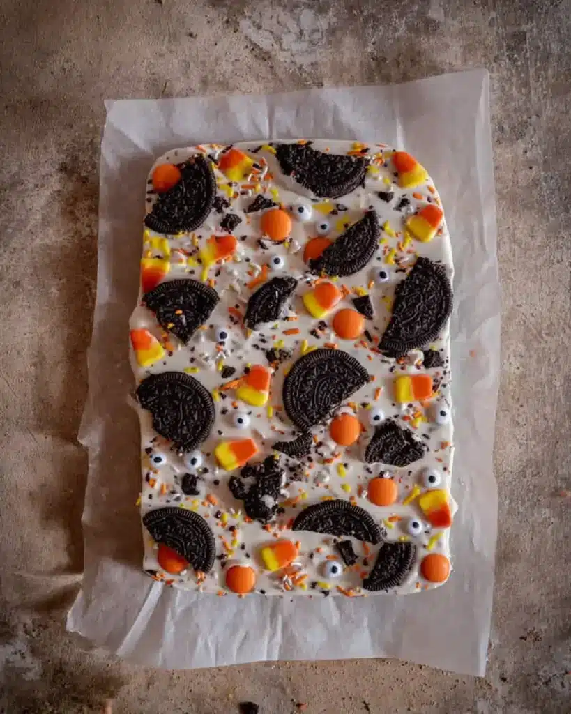 Halloween Oreo bark with toppings on melted white chocolate base