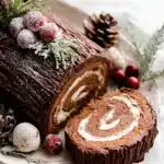 Yule Log Cake slice showing chocolate swirl and festive sugared cranberry decorations