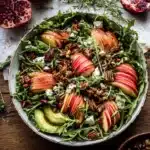 Autumn harvest apple and feta salad with arugula, pomegranate, and candied nuts