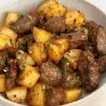 Garlic butter steak bites with golden potatoes in herb butter