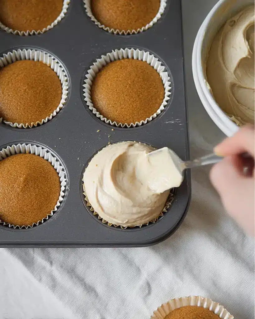 Filling gingerbread cheesecake cups with creamy spiced batter
