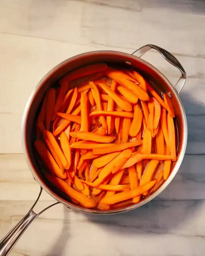 Carrots boiling in a pan for glazed carrots recipe