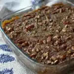 Freshly baked low carb pumpkin crisp with pecan topping in glass dish