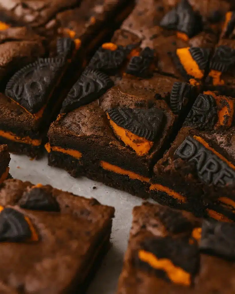 Halloween Oreo brownies with orange cream filling and chocolate cookie pieces