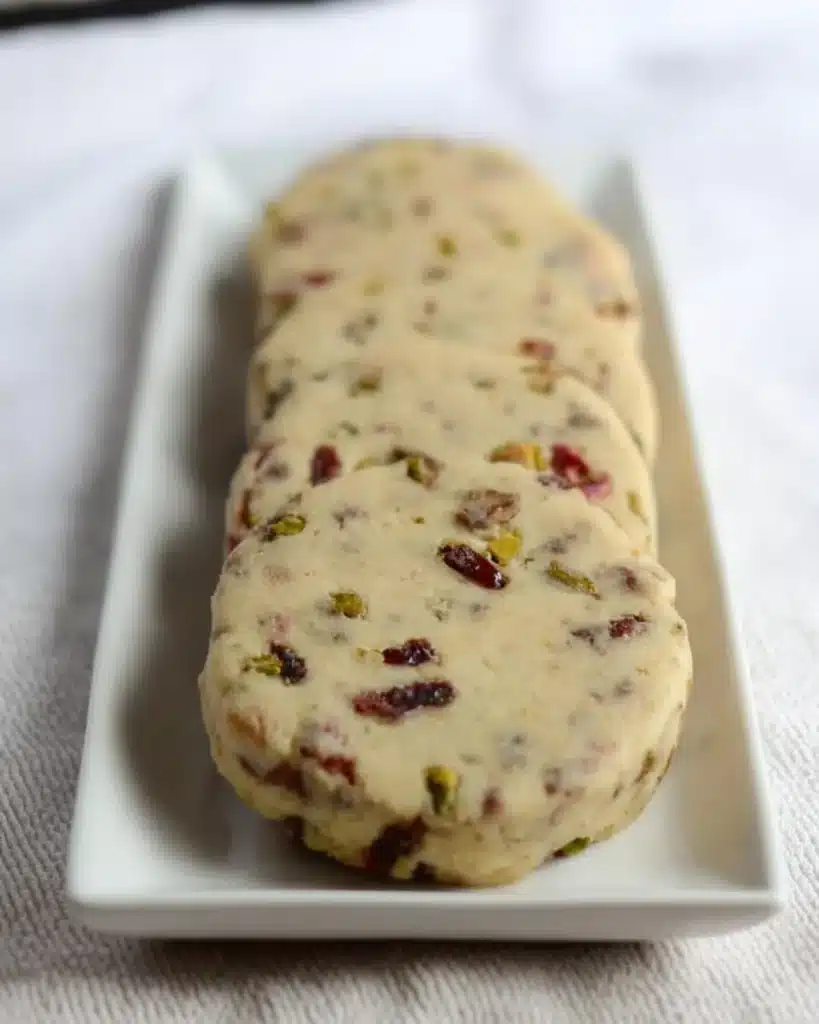 Cranberry pistachio shortbread cookies on a white plate