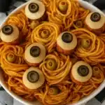 Spaghetti and eyeballs Halloween dinner with meatball eyeballs and olives