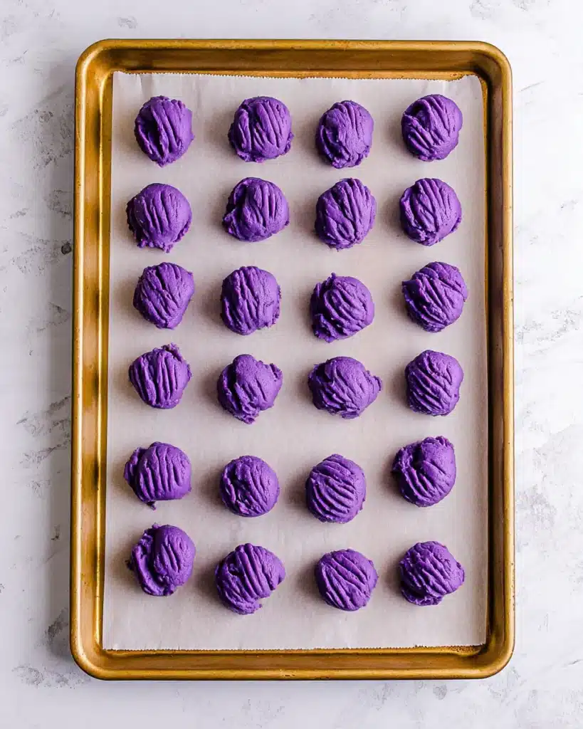 Purple Witch Hat Cookie dough balls on a parchment-lined baking tray