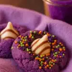 Purple witch hat cookies with striped chocolate kisses and Halloween sprinkles