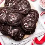 Chocolate peppermint cookies with crushed candy canes on a festive holiday background