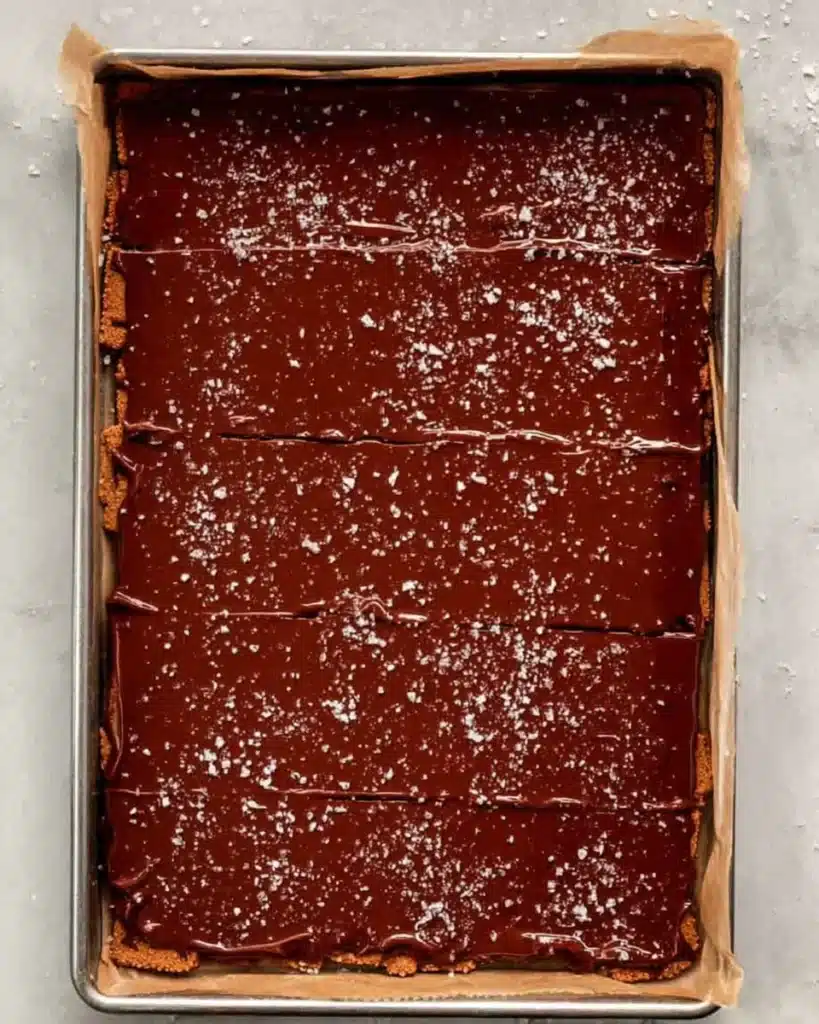 baking sheet with toffee crackers covered in melted chocolate and sea salt