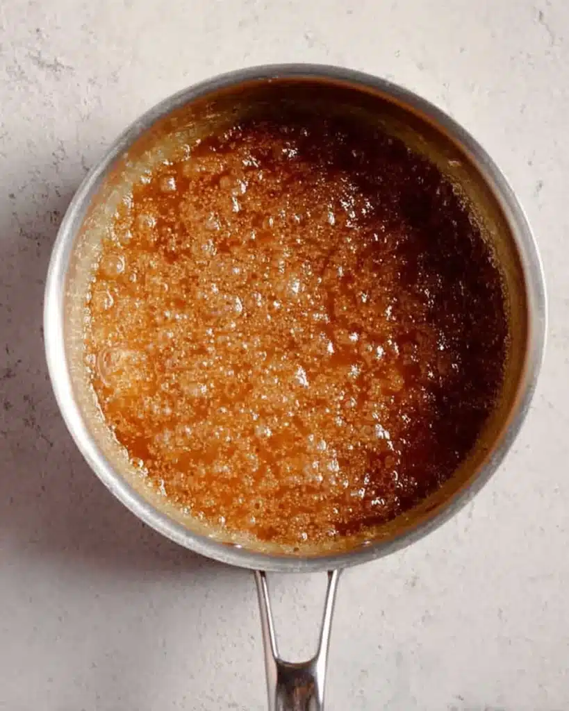 bubbling golden toffee sauce in saucepan for crack cookies