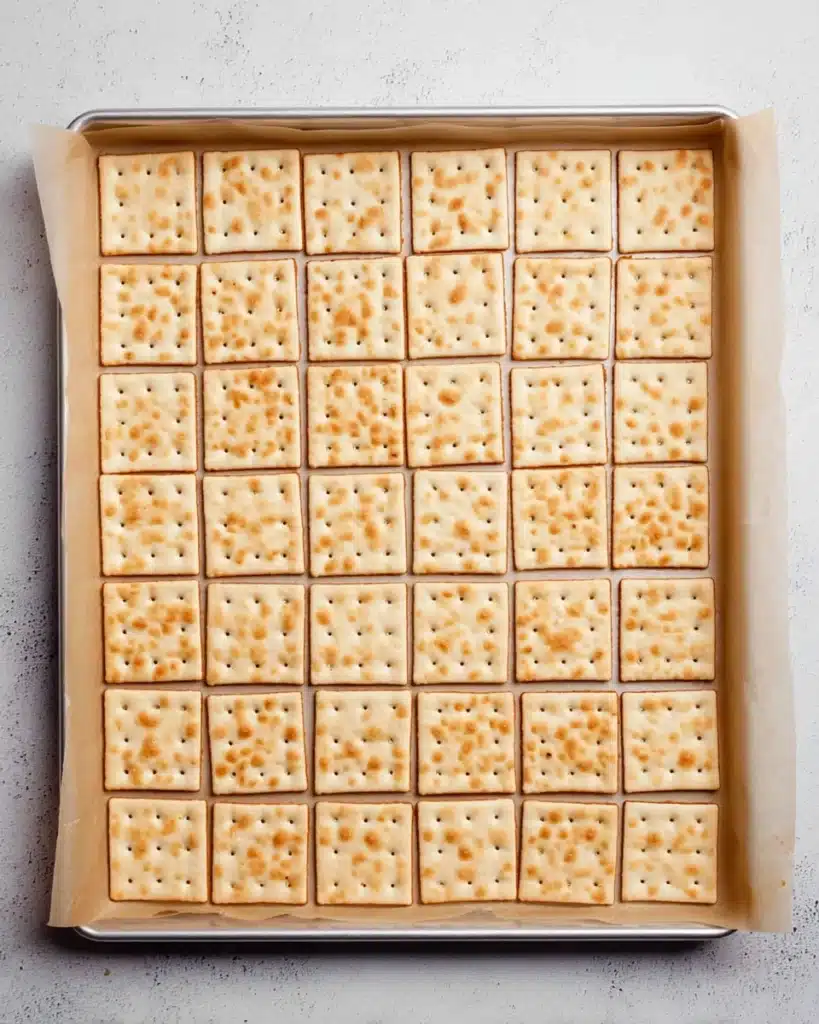 saltine crackers on baking sheet for crack cookies recipe